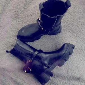 Black leather boots with gold buckles